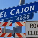 Composite photo of the "El Cajon Bl." road sign and road closure signs below.